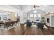 Open-concept living room and dining area with wood floors and plenty of natural light at 7560 S Biloxi Ct, Aurora, CO 80016