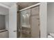 Modern bathroom shower featuring a sleek glass door and contemporary tile design at 7560 S Biloxi Ct, Aurora, CO 80016