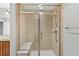 Modern walk-in shower equipped with a built-in seat and grab bars for convenience at 7560 S Biloxi Ct, Aurora, CO 80016