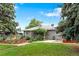Spacious backyard featuring a lush lawn, mature trees, a garden area, and a storage shed for outdoor convenience at 6755 W 45Th Ave, Wheat Ridge, CO 80033