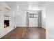 Finished basement featuring wood floors, brick fireplace, neutral walls, and a window for natural light at 6755 W 45Th Ave, Wheat Ridge, CO 80033