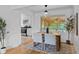 Bright dining room with hardwood floors, neutral rug, and an adjacent kitchen view at 6755 W 45Th Ave, Wheat Ridge, CO 80033