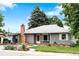 Charming single-story home with well-kept lawn, brick chimney, attached carport, and mature trees at 6755 W 45Th Ave, Wheat Ridge, CO 80033
