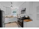 Kitchen with stainless steel appliances, modern white cabinets, and light countertops at 6755 W 45Th Ave, Wheat Ridge, CO 80033
