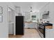 Bright kitchen with stainless steel appliances, white cabinets, and wood countertops, plus a washer-dryer closet at 6755 W 45Th Ave, Wheat Ridge, CO 80033