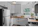 Sunlit kitchen featuring stainless steel appliances, white cabinets, and light countertops at 6755 W 45Th Ave, Wheat Ridge, CO 80033