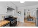 Well-equipped kitchen with stainless steel appliances and bright white cabinetry, open to the dining area at 6755 W 45Th Ave, Wheat Ridge, CO 80033