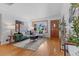 Bright living room boasts hardwood floors, a bay window, stylish furnishings, and a decorative front door at 6755 W 45Th Ave, Wheat Ridge, CO 80033