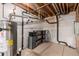 Utility area of basement with water heater and black piping at 7580 S Biloxi Ct, Aurora, CO 80016