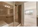 Bathroom featuring glass-enclosed shower with tile surround and neutral color palette at 7580 S Biloxi Ct, Aurora, CO 80016