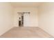 Spacious bedroom with plush carpet and sliding barn door to ensuite bathroom and walk-in closet at 7580 S Biloxi Ct, Aurora, CO 80016