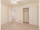 Bedroom featuring ceiling fan, carpet, closet with sliding doors, and white walls at 7580 S Biloxi Ct, Aurora, CO 80016