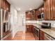 Open kitchen with stainless steel appliances, granite countertops, wood floors, and view of a dining area at 7580 S Biloxi Ct, Aurora, CO 80016