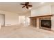 Inviting living room featuring a fireplace, neutral carpet, and open access to other living areas at 7580 S Biloxi Ct, Aurora, CO 80016