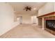 Spacious living room with a warm fireplace, neutral carpet, and ample natural light at 7580 S Biloxi Ct, Aurora, CO 80016