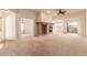 Bright living room featuring a cozy fireplace, neutral carpet, and access to the outdoor balcony at 7580 S Biloxi Ct, Aurora, CO 80016
