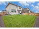 Well-manicured lawn in the backyard with a patio and wooden fence, perfect for outdoor relaxation and entertaining at 14818 Dahlia St, Thornton, CO 80602
