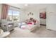 bedroom featuring a charming bed, toy storage, and access to a walk-in closet at 14818 Dahlia St, Thornton, CO 80602