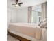 Light and airy bedroom with a ceiling fan and large window at 14818 Dahlia St, Thornton, CO 80602