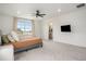 Bright bedroom with a ceiling fan, a large window, and an adjacent walk-in closet at 14818 Dahlia St, Thornton, CO 80602