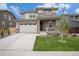 Stylish two-story home with a spacious two-car garage, stone details, and a welcoming front lawn at 14818 Dahlia St, Thornton, CO 80602