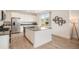 Bright kitchen with white cabinets, stainless steel appliances, and a large island with bar seating at 14818 Dahlia St, Thornton, CO 80602