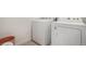 A well-equipped laundry area with white appliances and neutral decor at 14818 Dahlia St, Thornton, CO 80602
