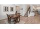 Stylish open-concept living area with wood floors, stairs, and an adjacent kitchen and dining space at 14818 Dahlia St, Thornton, CO 80602