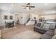 Spacious living area with wood floors, modern decor, and an open layout to the kitchen and dining area at 14818 Dahlia St, Thornton, CO 80602