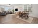 Bright open-plan living room with wood floors, stylish furnishings, and lots of natural light at 14818 Dahlia St, Thornton, CO 80602
