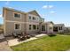 Grassy backyard with a paved patio and outdoor seating area at 13041 Reata Ridge Dr, Parker, CO 80134
