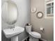 Cozy half bathroom with pedestal sink and decorative mirrors at 13041 Reata Ridge Dr, Parker, CO 80134