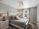 Cozy bedroom featuring a queen-sized bed, nightstands with lamps, and a window providing natural light at 13041 Reata Ridge Dr, Parker, CO 80134