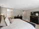 The main bedroom features a large comfortable bed, dark dressers, and a connected bathroom with soaking tub at 13041 Reata Ridge Dr, Parker, CO 80134