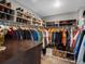 A well-organized walk-in closet with clothing racks, shoe shelves, and storage solutions at 13041 Reata Ridge Dr, Parker, CO 80134