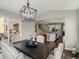 Dining room with dark wood table and seating view to kitchen and staircase at 13041 Reata Ridge Dr, Parker, CO 80134