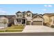 Charming two-story home with a three-car garage, covered porch, and a well-manicured lawn at 13041 Reata Ridge Dr, Parker, CO 80134