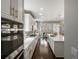 Spacious kitchen featuring white cabinets, quartz countertops, and stainless steel appliances at 13041 Reata Ridge Dr, Parker, CO 80134