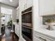 Modern kitchen featuring stainless steel double oven and white countertops at 13041 Reata Ridge Dr, Parker, CO 80134