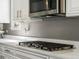Modern kitchen featuring stainless steel gas range, white countertops and cabinets at 13041 Reata Ridge Dr, Parker, CO 80134
