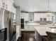 Modern kitchen with stainless steel appliances, white cabinets, and quartz countertops at 13041 Reata Ridge Dr, Parker, CO 80134