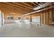 Unfinished basement with exposed wood beams and plenty of natural light, ready to be customized at 1388 Castle Creek Cir, Castle Rock, CO 80104