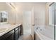 Bathroom with double sink vanity, soaking tub, and natural light at 1388 Castle Creek Cir, Castle Rock, CO 80104