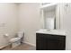 Clean bathroom features a single sink, toilet, and a well-lit mirror, offering practicality at 1388 Castle Creek Cir, Castle Rock, CO 80104