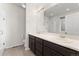 Bright bathroom features double sinks, large mirror, white countertops and glass enclosed shower at 1388 Castle Creek Cir, Castle Rock, CO 80104