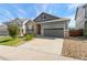 Attractive home with a two-car garage and landscaped front yard at 1388 Castle Creek Cir, Castle Rock, CO 80104