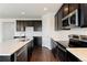 Modern kitchen with stainless steel appliances and dark wood cabinets with white countertops at 1388 Castle Creek Cir, Castle Rock, CO 80104