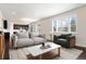 Bright living room featuring plantation shutters at 1388 Castle Creek Cir, Castle Rock, CO 80104