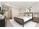 Bright main bedroom with modern decor, dresser, king bed, and walk-in closet at 1388 Castle Creek Cir, Castle Rock, CO 80104