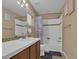 Bathroom featuring a sink with tiled countertop and shower with a shower curtain at 413 N De Gaulle Ct, Aurora, CO 80018